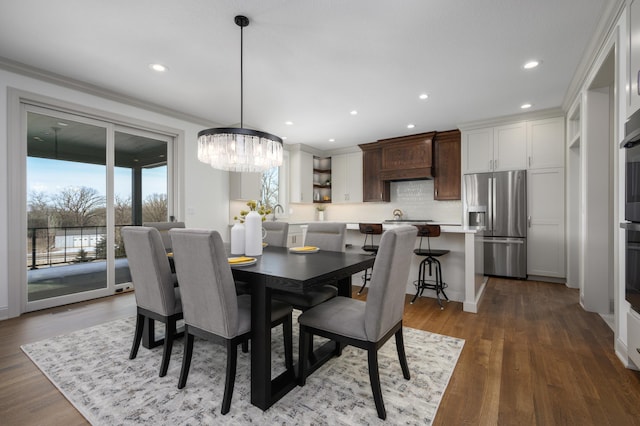 dining room featuring hardwood / wood-style flooring and ornamental molding