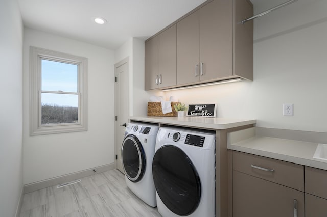 laundry area featuring cabinets and independent washer and dryer