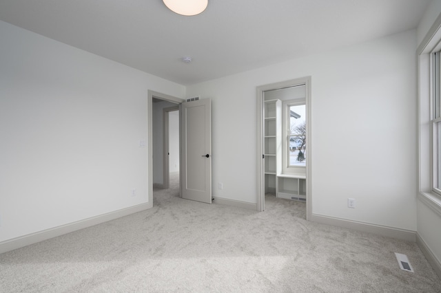 unfurnished bedroom featuring light colored carpet