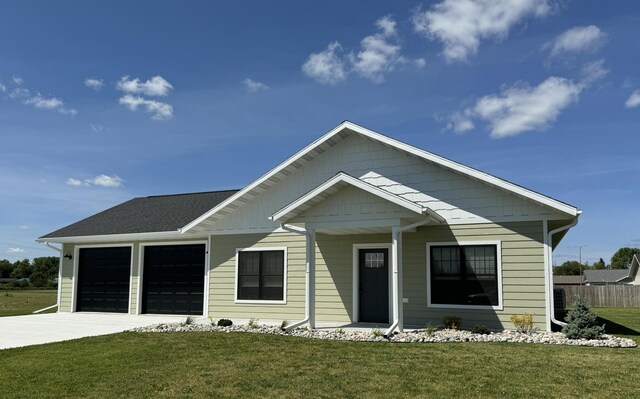 view of front of property with a garage and a front lawn