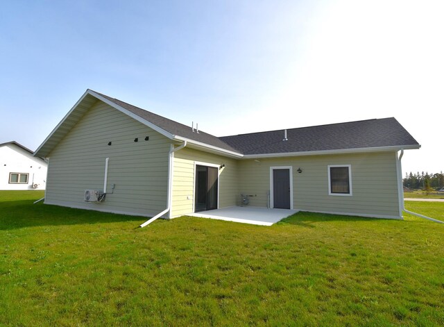 rear view of house featuring a patio and a lawn