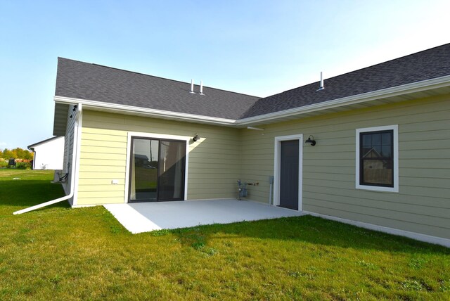 rear view of house featuring a patio area and a lawn