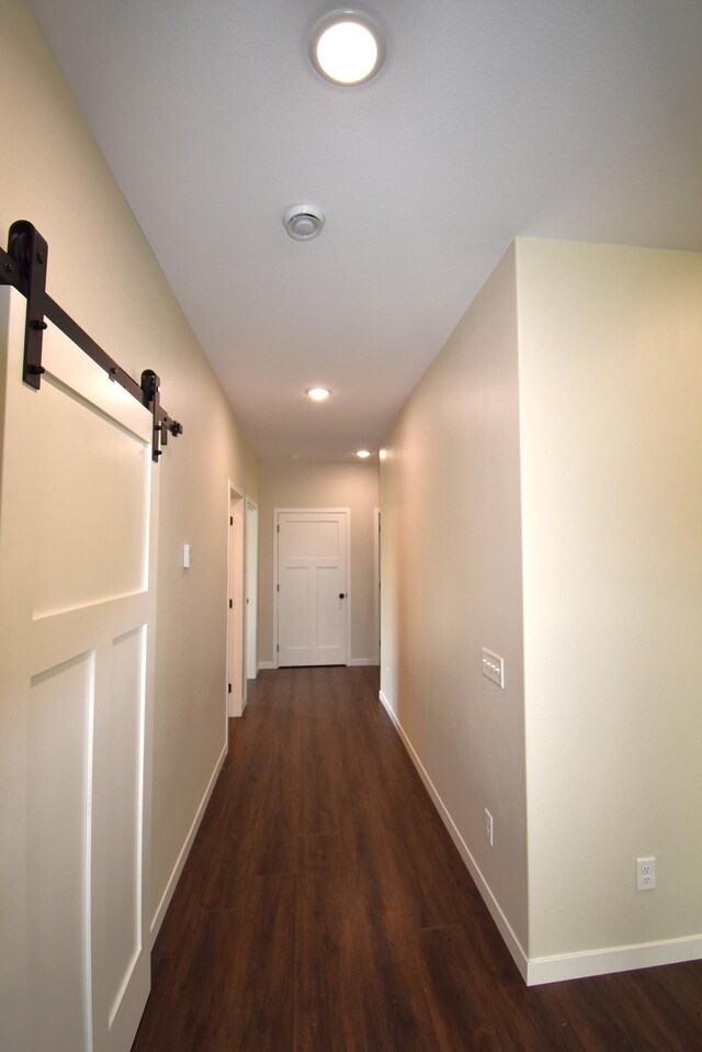 hall featuring a barn door and hardwood / wood-style floors