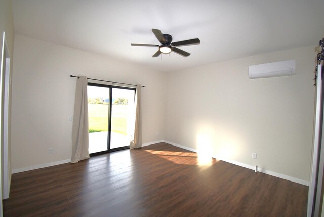 spare room featuring dark hardwood / wood-style floors, a wall mounted AC, and ceiling fan