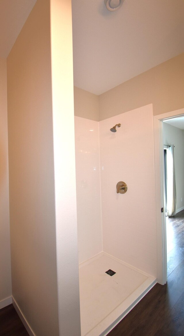 bathroom with walk in shower and hardwood / wood-style flooring