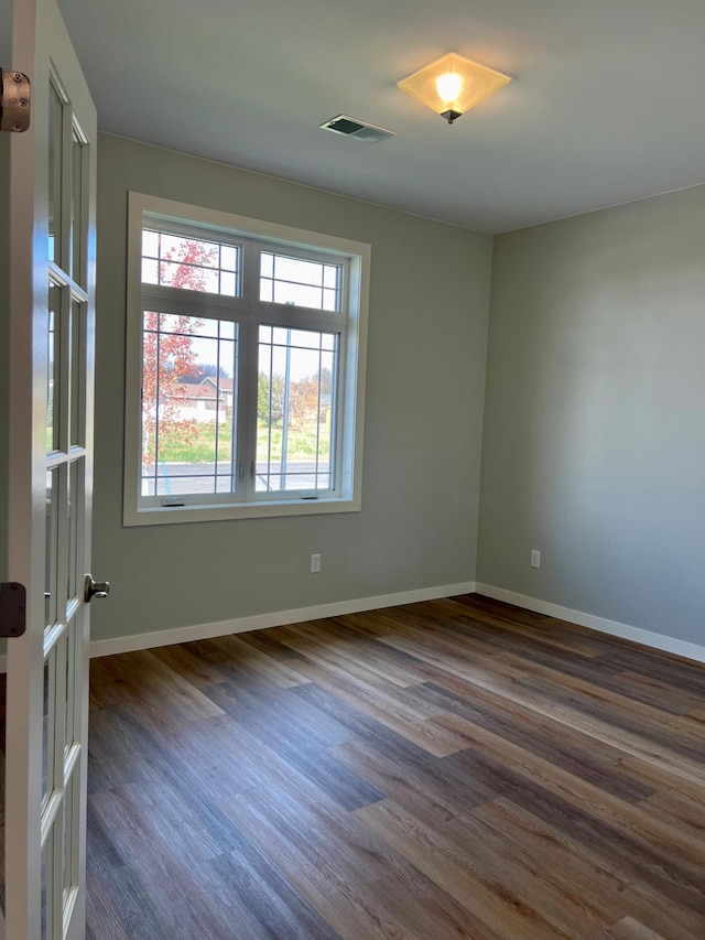 spare room with dark hardwood / wood-style flooring