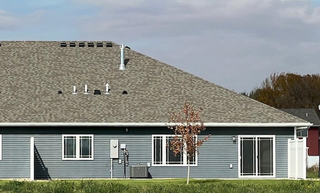 rear view of house with central air condition unit