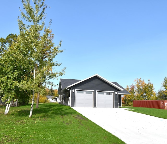 view of side of home with a garage and a yard