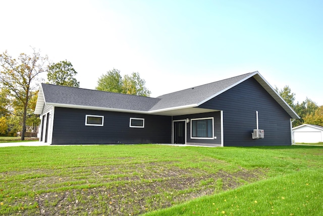 single story home with cooling unit, a garage, and a front yard