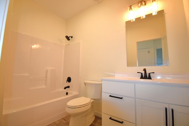 full bathroom with bathtub / shower combination, hardwood / wood-style flooring, vanity, and toilet