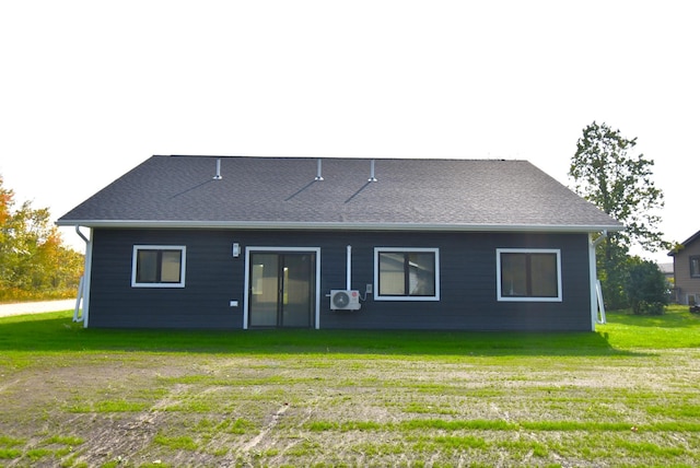 rear view of house featuring a lawn