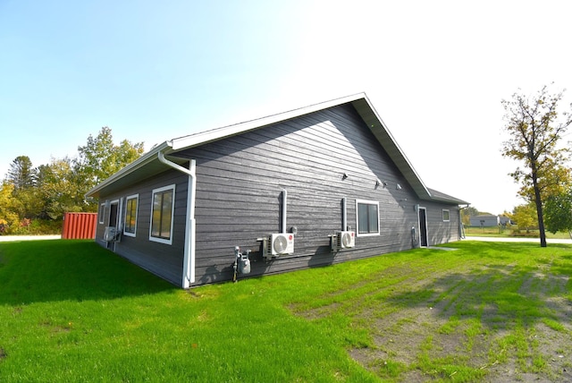 view of home's exterior featuring a lawn and ac unit