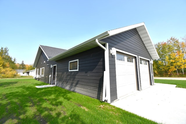 garage featuring a lawn