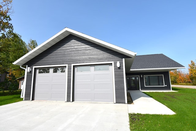 single story home with a front yard and a garage