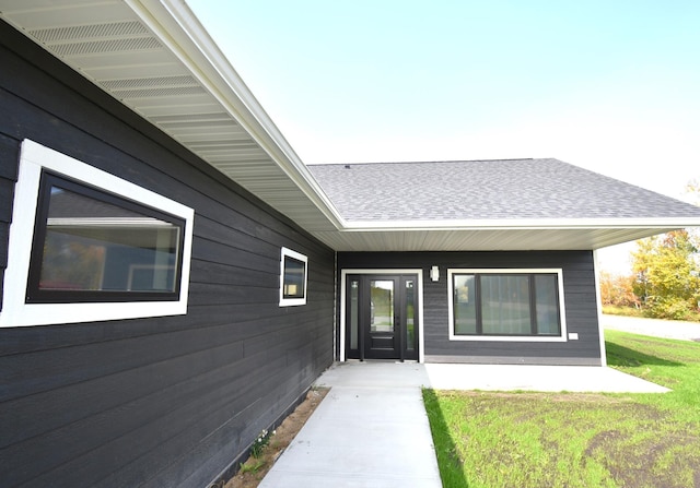 entrance to property with a lawn