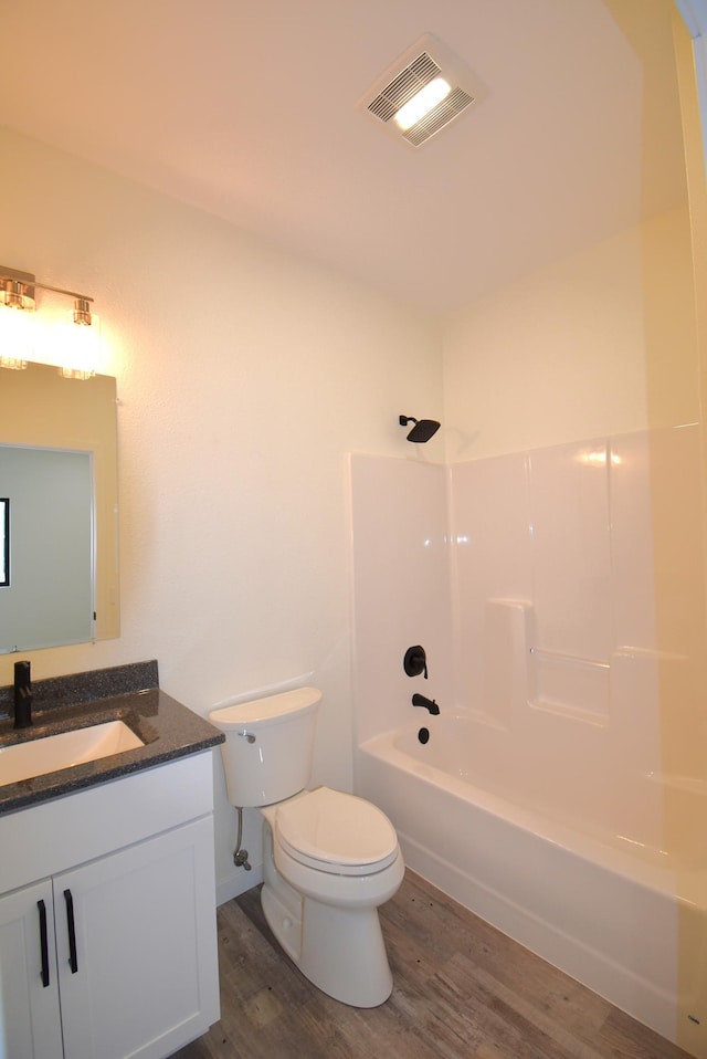 full bathroom featuring shower / tub combination, hardwood / wood-style flooring, vanity, and toilet