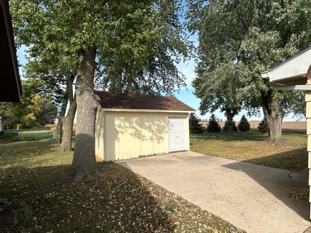 view of side of property featuring a shed and a lawn