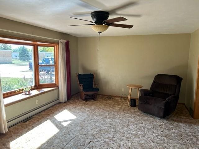 unfurnished room featuring light colored carpet, baseboard heating, and ceiling fan