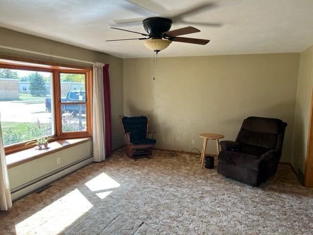 306 9th St, Westbrook, MN 56183 - sitting room with baseboard heating, a ceiling fan, and carpet floors