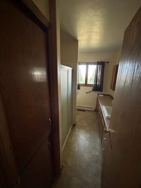 306 9th St, Westbrook, MN 56183 - bathroom with baseboard heating, a stall shower, tile patterned floors, and vanity