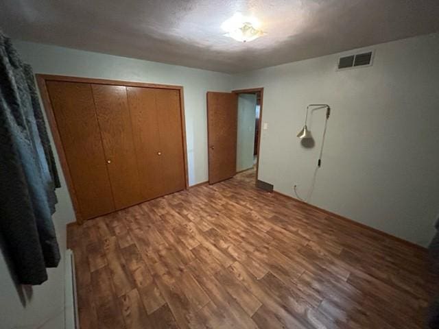 306 9th St, Westbrook, MN 56183 - unfurnished bedroom with wood finished floors and a closet