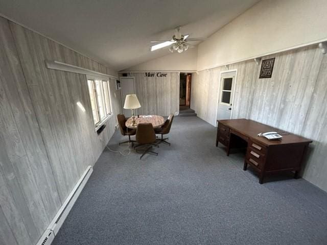 interior space with ceiling fan, baseboard heating, vaulted ceiling, and carpet