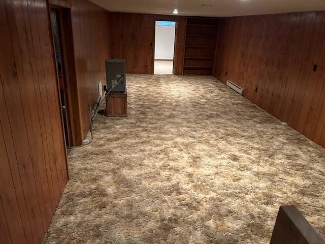 306 9th St, Westbrook, MN 56183 - finished below grade area featuring carpet floors, wooden walls, and a baseboard radiator