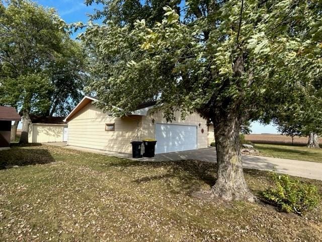 view of side of property with a garage and a yard