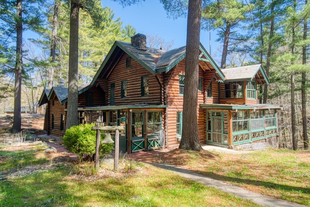 view of side of home featuring a sunroom