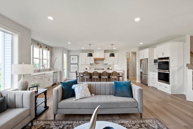 living area featuring recessed lighting and light wood-style flooring