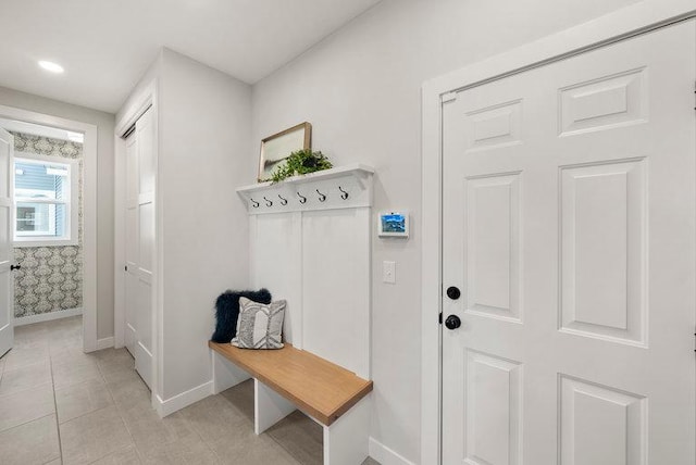 mudroom featuring recessed lighting, baseboards, and light tile patterned flooring