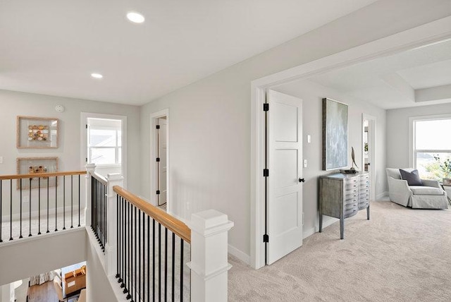 corridor with recessed lighting, baseboards, light carpet, and an upstairs landing