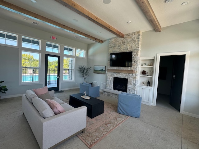 living room with a stone fireplace, a high ceiling, beam ceiling, and baseboards