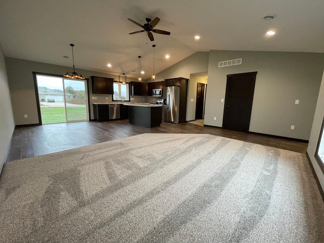 unfurnished living room featuring ceiling fan, vaulted ceiling, and dark hardwood / wood-style flooring