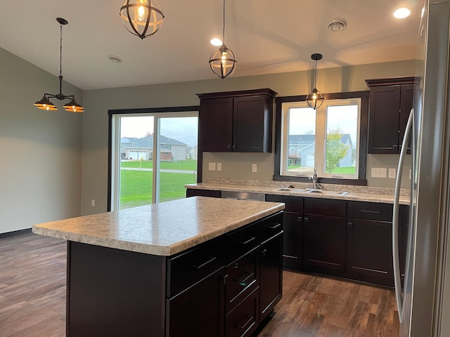 kitchen featuring pendant lighting, a center island, dark hardwood / wood-style floors, and sink