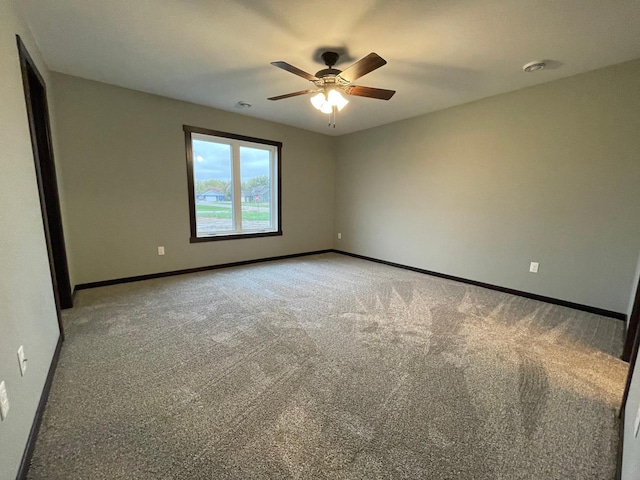 spare room featuring ceiling fan and carpet floors