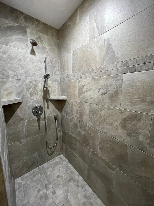 bathroom with tiled shower