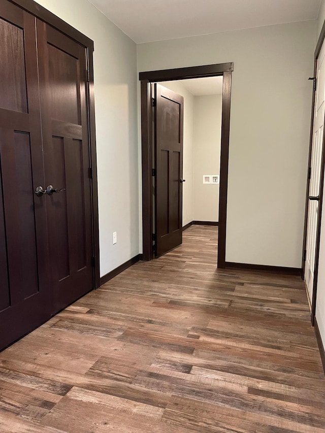 unfurnished bedroom with light wood-type flooring and a closet