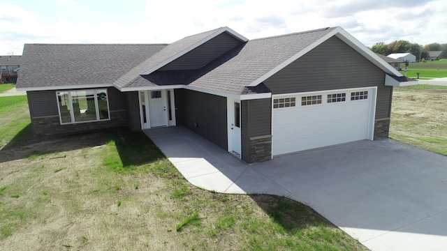 view of front of house featuring a garage and a front lawn