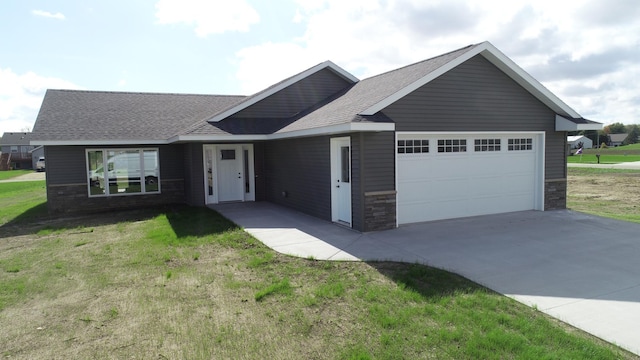 view of front facade with a front yard and a garage