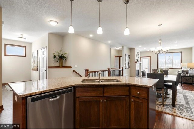 kitchen featuring decorative light fixtures, dark hardwood / wood-style flooring, a chandelier, and dishwasher