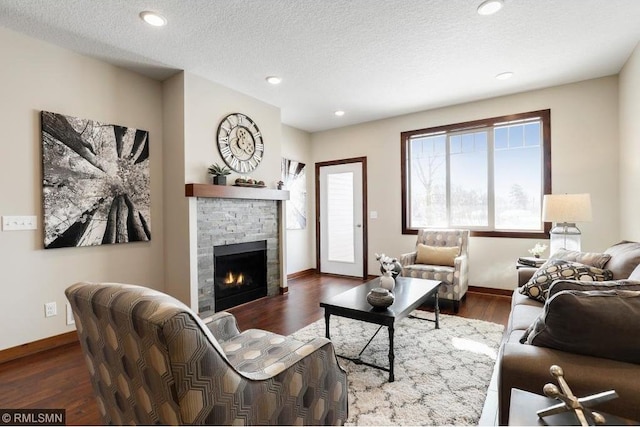 living room with a textured ceiling and dark hardwood / wood-style floors