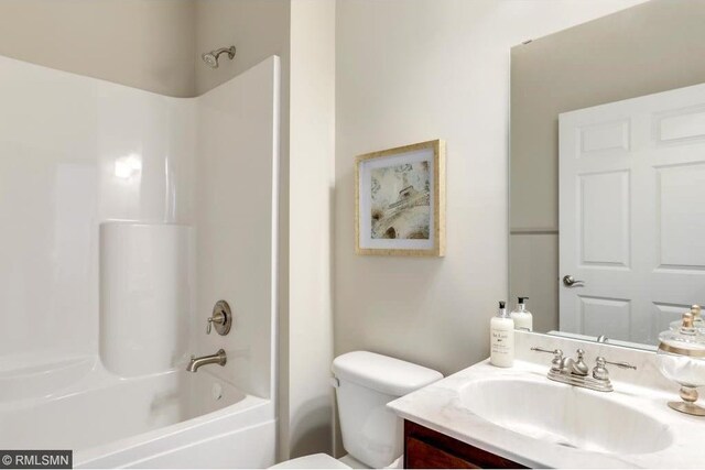 full bathroom featuring shower / tub combination, toilet, and vanity with extensive cabinet space