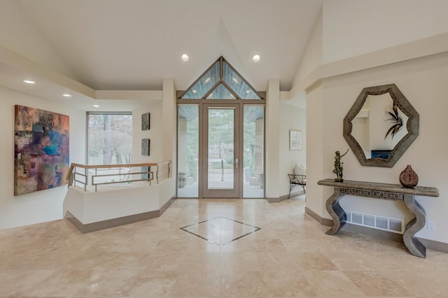 foyer with french doors and high vaulted ceiling