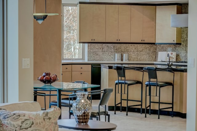 kitchen featuring backsplash, a wealth of natural light, sink, and light brown cabinets