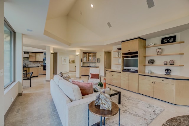 living room with high vaulted ceiling