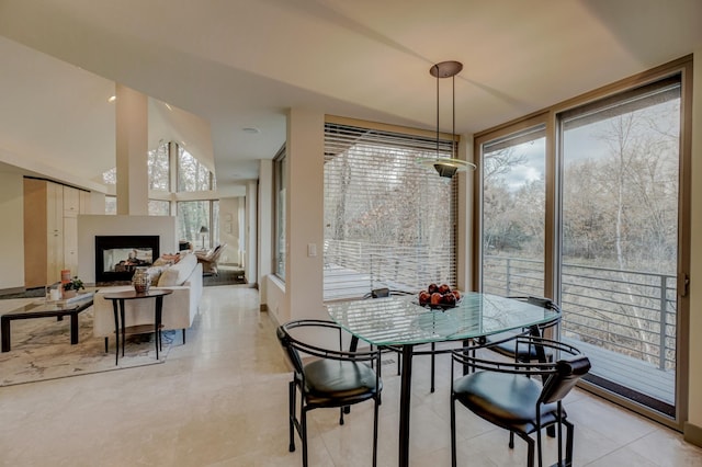 1 Capaul Woods Ct, North Oaks, MN 55127 - dining area with light tile patterned flooring and a multi sided fireplace