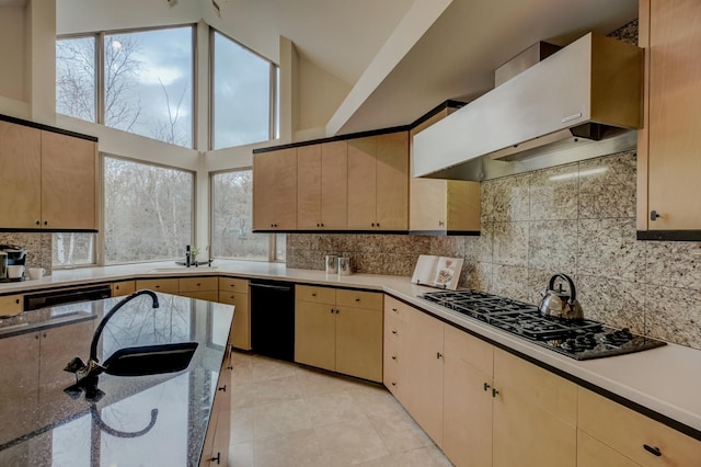 kitchen with dishwasher, backsplash, a high ceiling, wall chimney range hood, and gas stovetop