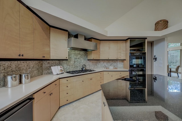 kitchen featuring gas cooktop, decorative backsplash, stainless steel dishwasher, sink, and wall chimney range hood