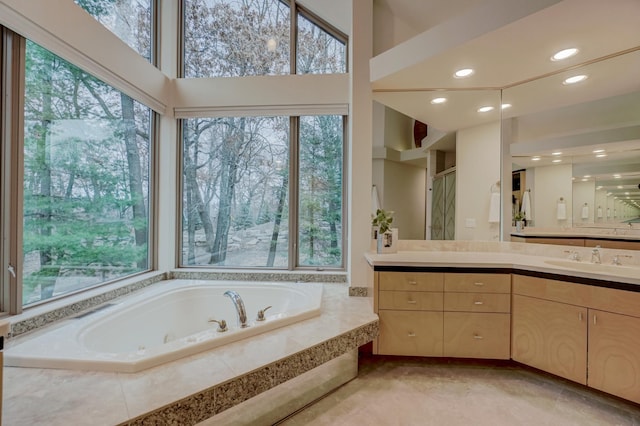 1 Capaul Woods Ct, North Oaks, MN 55127 - bathroom featuring healthy amount of natural light, a garden tub, vanity, recessed lighting, and a shower with shower door